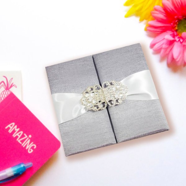 Crystalline Silk Gateway: Ivory Fold Invite with Gem Clasp Accent